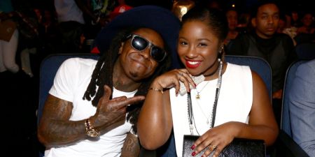 Reginae Carter poses a picture with her celebrity dad, Lil Wayne.